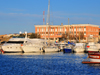 Porto Torres / Pòltu Tòrra, Sassari province, Sardinia / Sardegna / Sardigna: the harbour, built over its Roman predecessor - yachts and Coast Guard building - Cormorano Marina - photo by M.Torres
