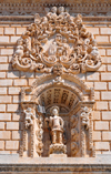 Sassari / Tàthari, Sassari province, Sardinia / Sardegna / Sardigna: Cathedral of St. Nicholas of Bari - niche with St Gianuario killed in Porto Torres in the 4th century AD, one of the 'martiri turritani' - medallion with the Madonna del Bosco - façade detail - photo by M.Torres