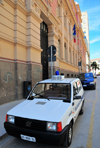 Sassari / Tàthari, Sassari province, Sardinia / Sardegna / Sardigna: Via Brigata Sassari - Fiat Panda of the Municipal Police in front of the Central Post Office - Palazzo delle Poste e Telegrafi - designed by the engineer Bruno Cipelli - photo by M.Torres